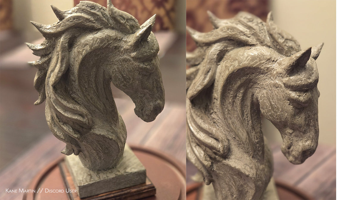Two stone horse head sculptures on a striped fabric background